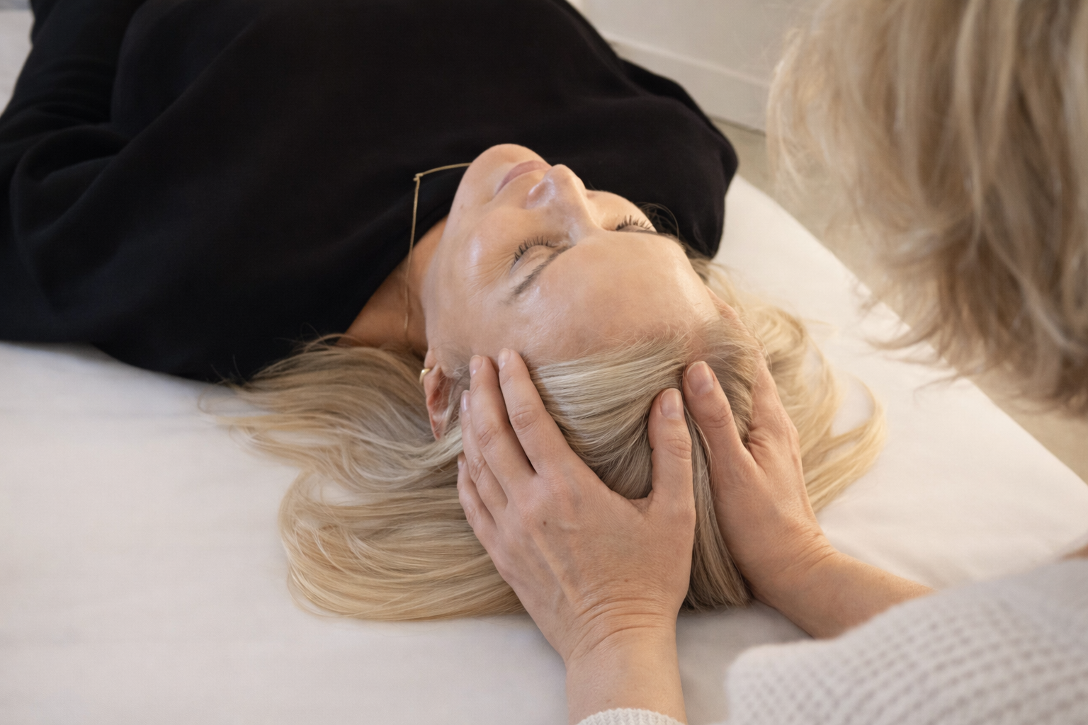 Practitioner doing therapeutic somatic work on patient to support alignment, release tension