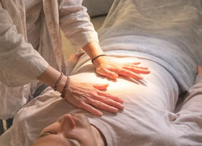 Our practitioner doing Energy Balancing work on a client to clear blockages and restore balance