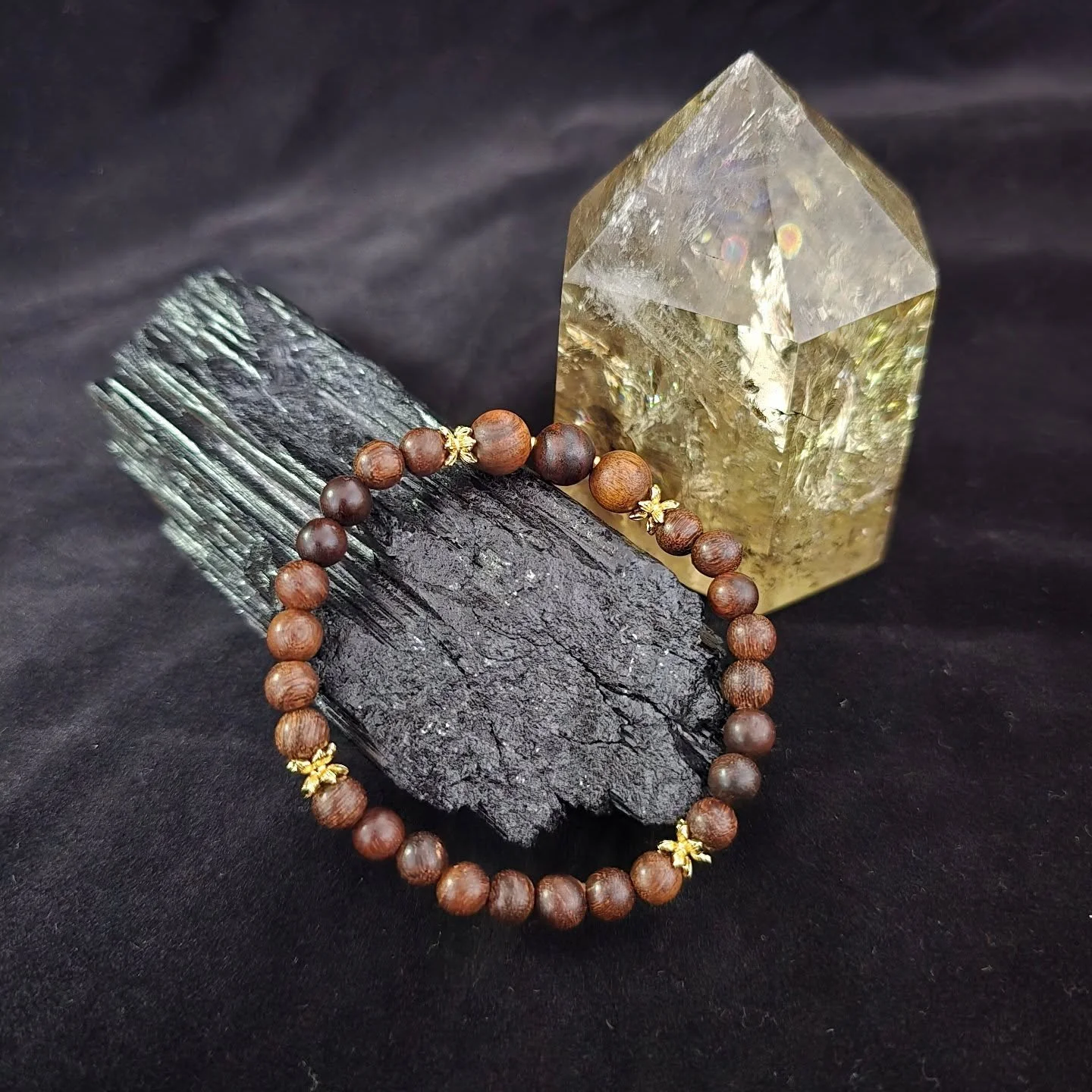 A personal favourite from the Wood Collection. 
Sandalwood completed with gold lotus spacers

This piece was made with the idea of using significant numbers in Buddhism:
- 3 bigger beads: Three Jewels
- 8 smaller beads: the Noble Eightfold Path
- 4 l