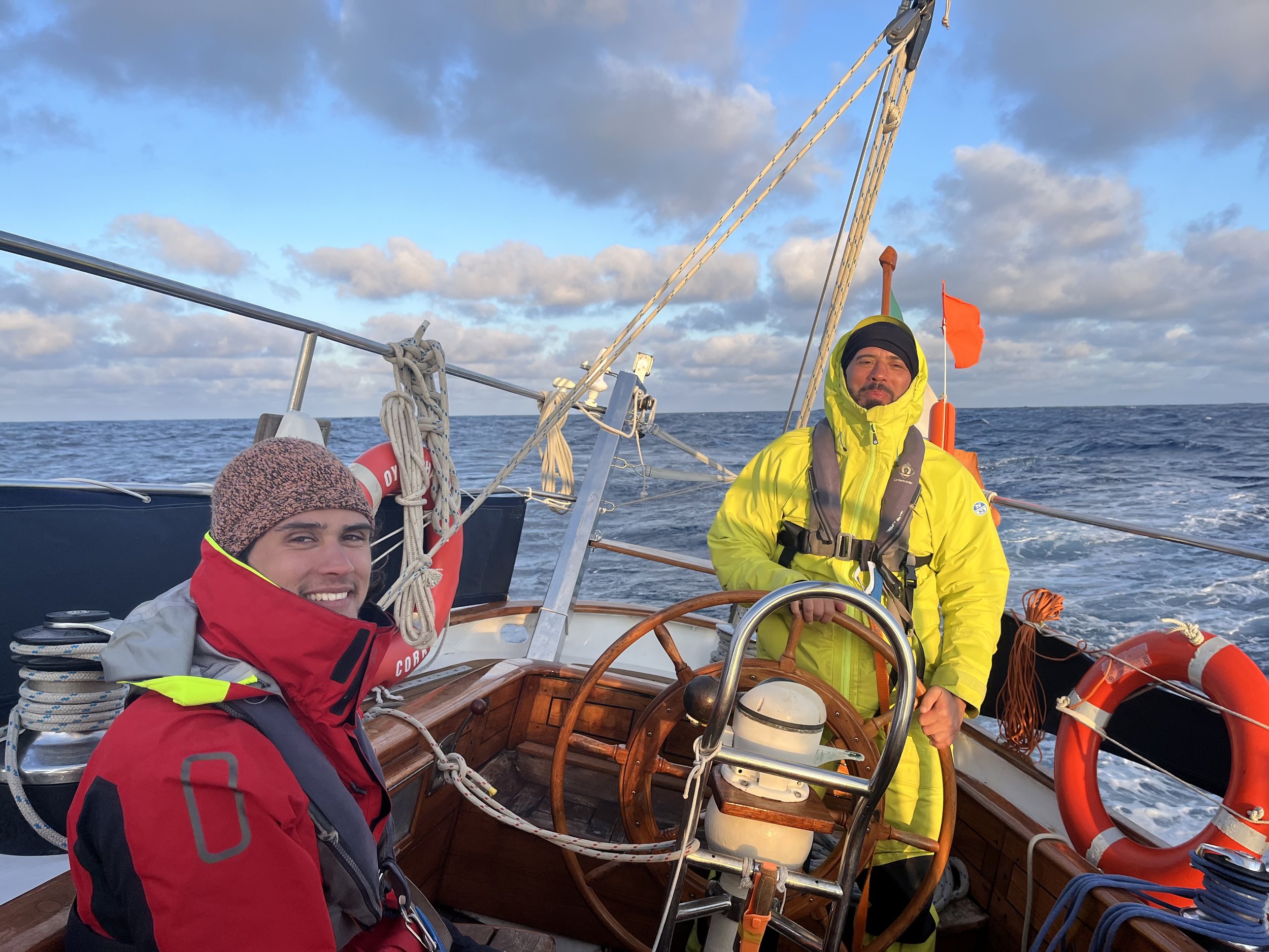 Skipper steering the schooner Spirit of Ostend while sailing offshore.
