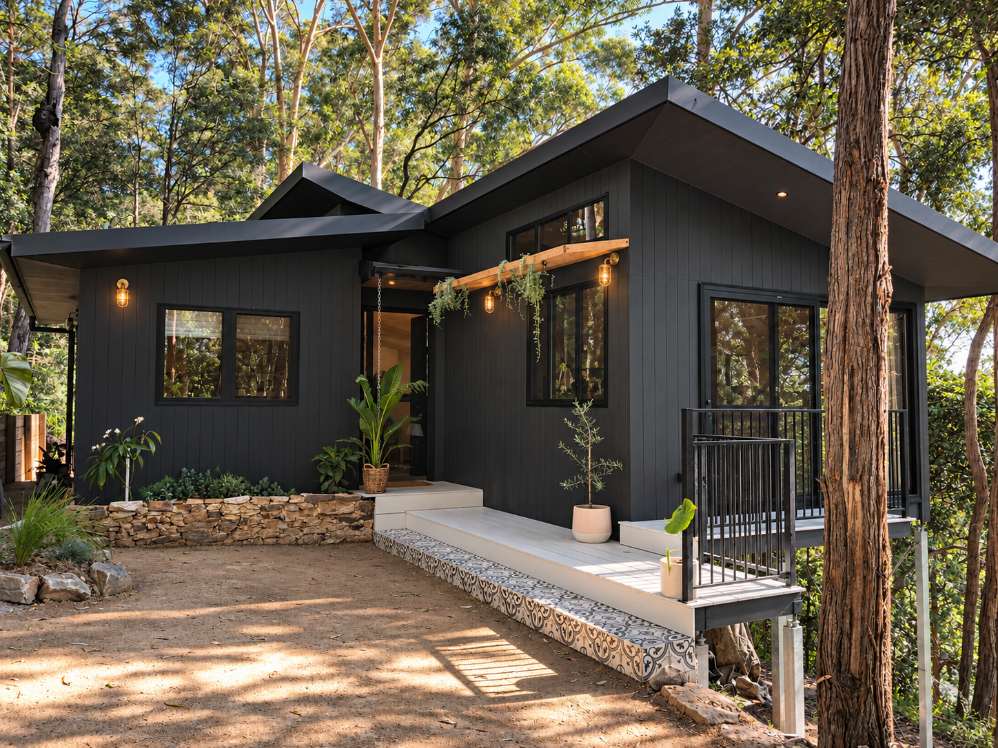 Modern black house with multiple level entrances, surrounded by trees and plants, with a wooden and tiled exterior, metal railings, and hanging light bulbs.