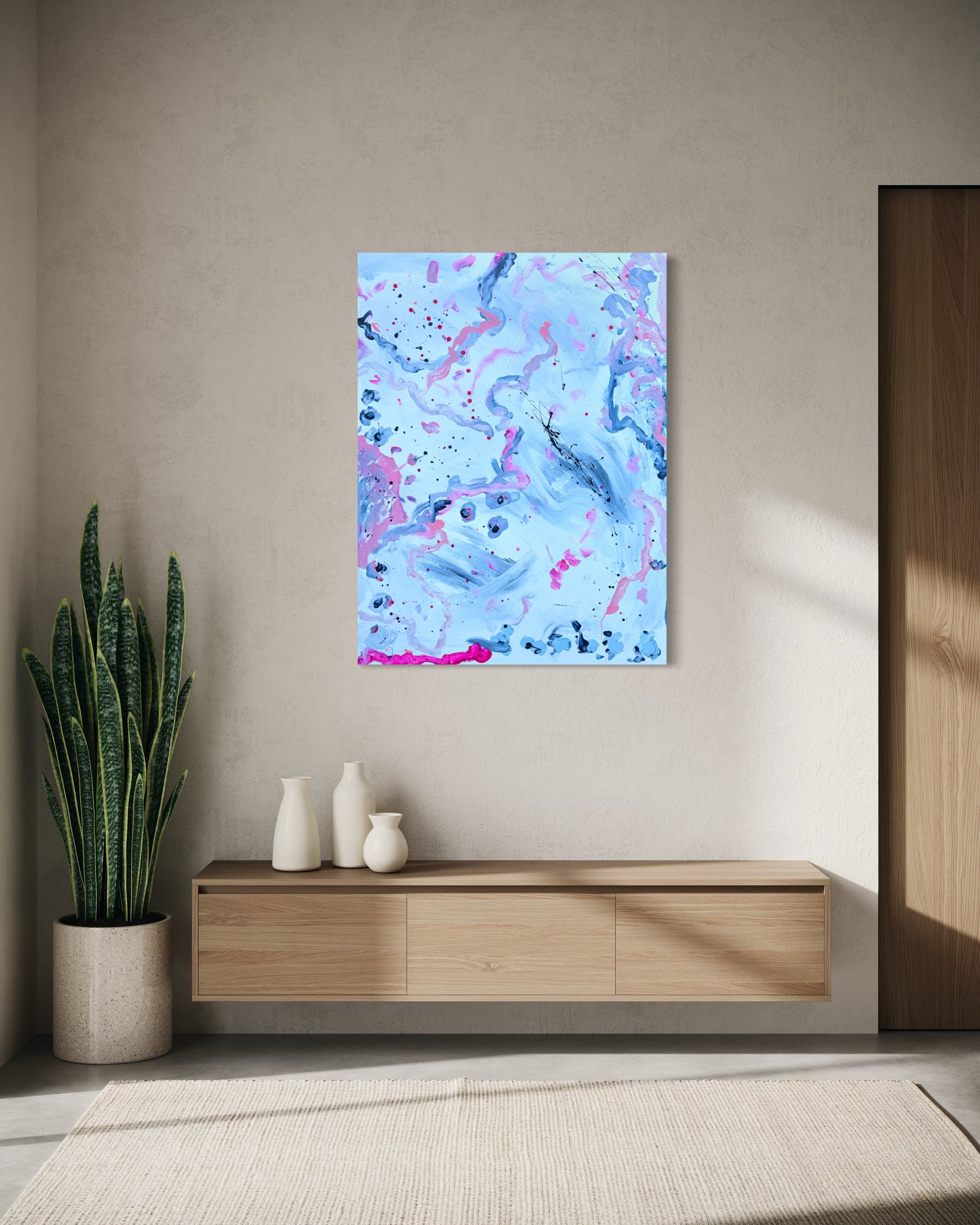 A modern living room wall with an abstract painting, a wooden console with three white ceramic vases, a tall potted snake plant to the left, a beige area rug on the floor, and a wooden panel on the right side.