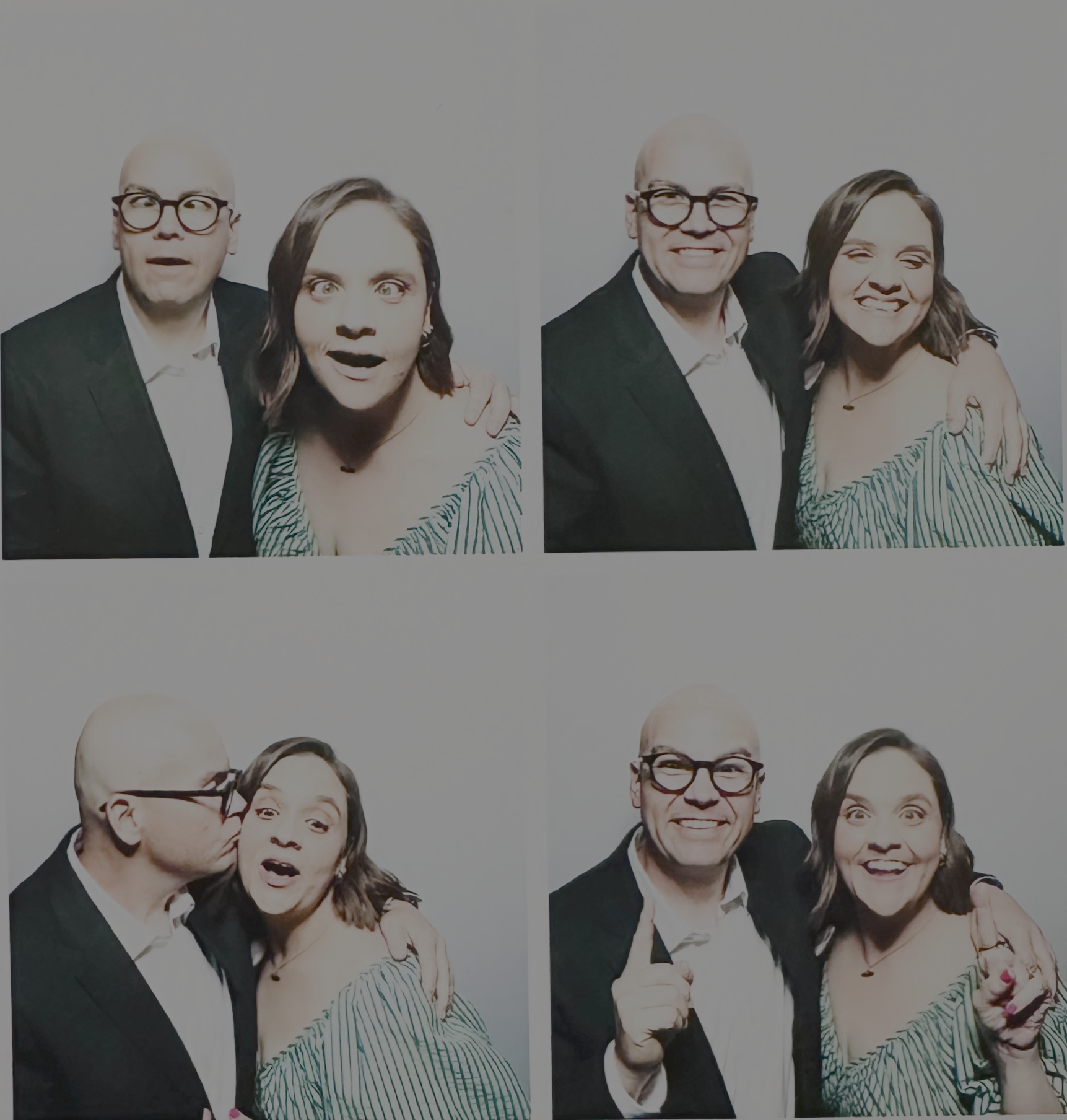 Two people posing for the camera with animated expressions and gestures. One man in green suit and one woman in striped dress, set against a plain white background.