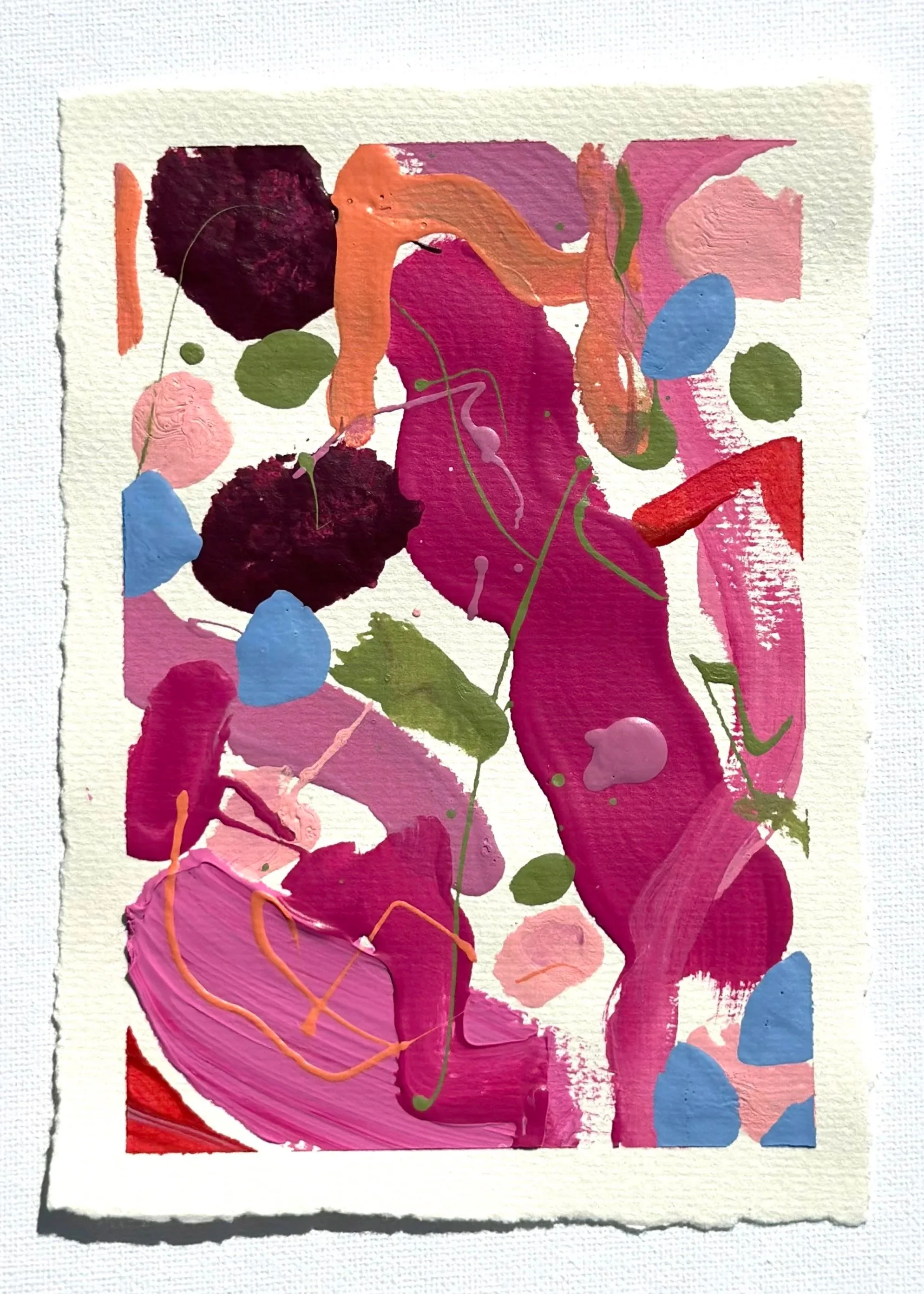 Abstract colorful painting with pink, red, purple, green, orange, and blue paint splashes and strokes, on textured white paper.