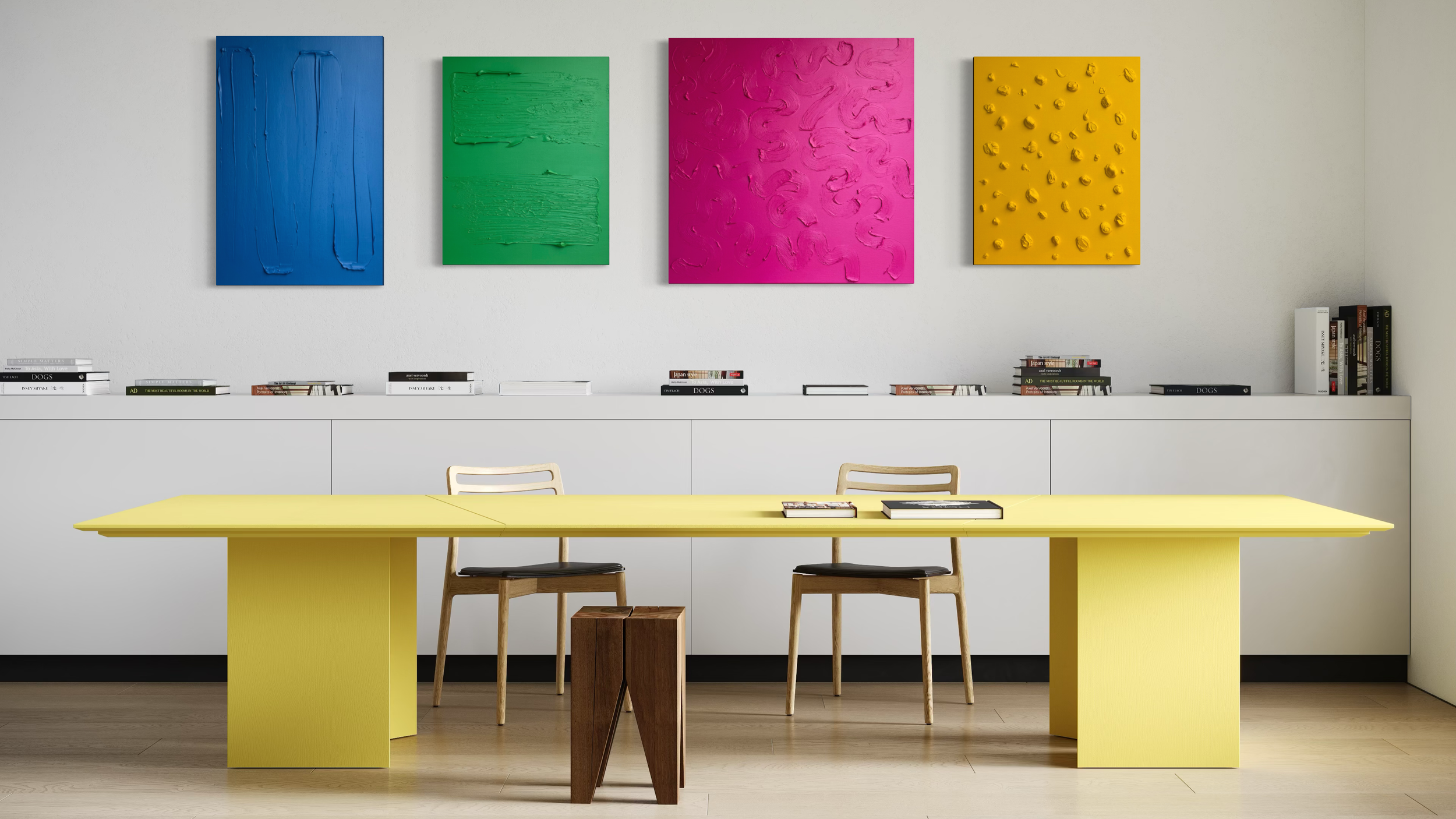 Modern art gallery with four colorful abstract paintings on the wall above a white sideboard, and a yellow table with chairs in the foreground.