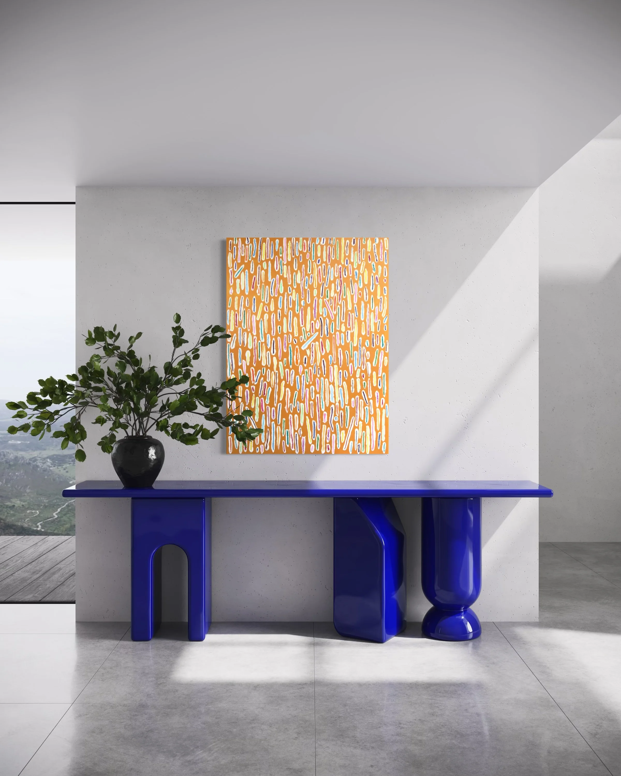 Interior of a modern room with a blue console table, a potted plant, a colorful abstract wall hanging, and gray tiled flooring.