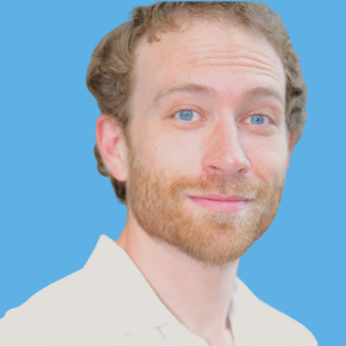 Photo of Dr. Alberto Prati, with curly hair and a beard, smiling, wearing a white shirt against a blue background.
