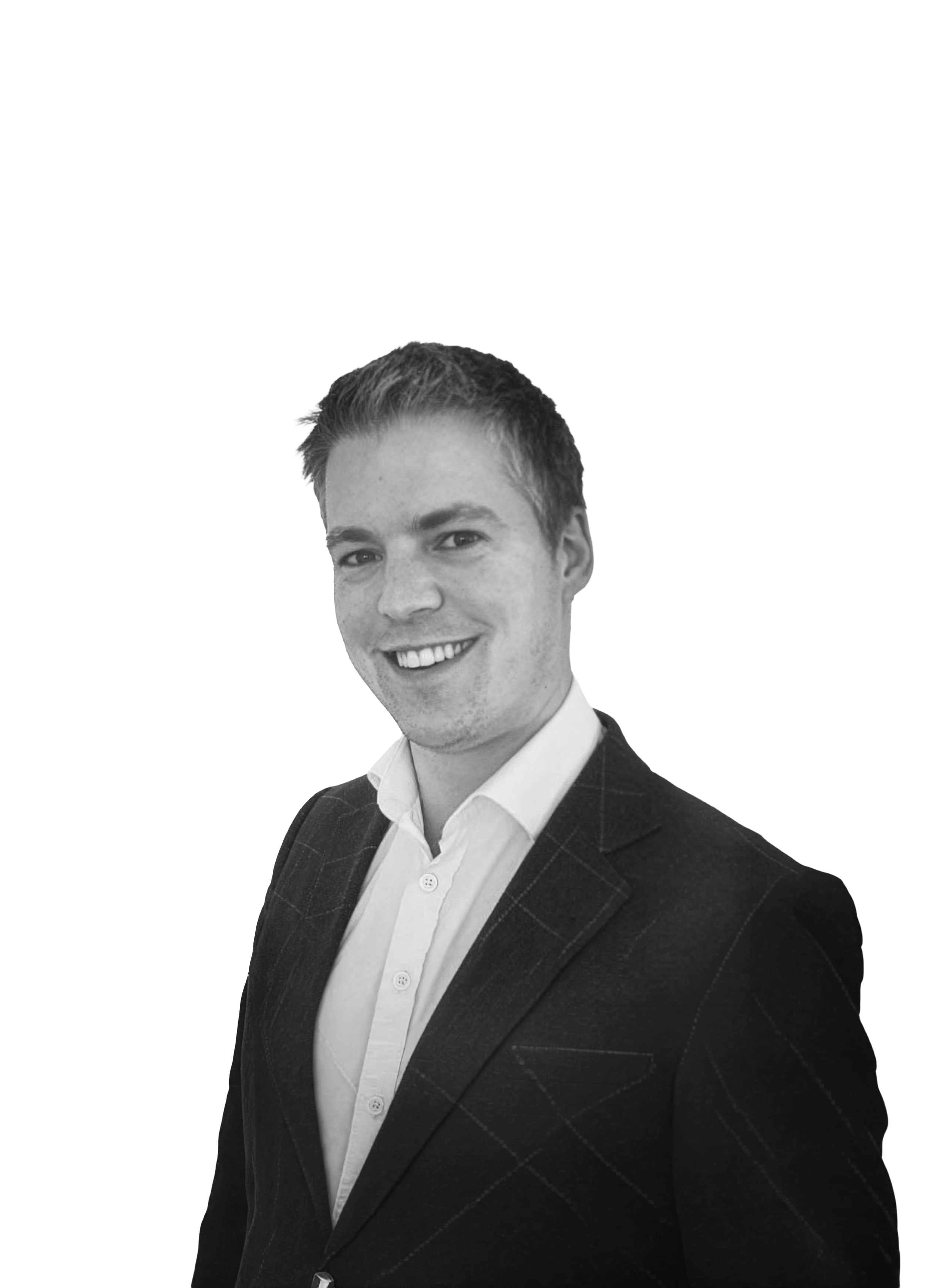 Black and white photo of a young man with short hair, smiling, wearing a plaid suit jacket and a white shirt, against a plain white background.