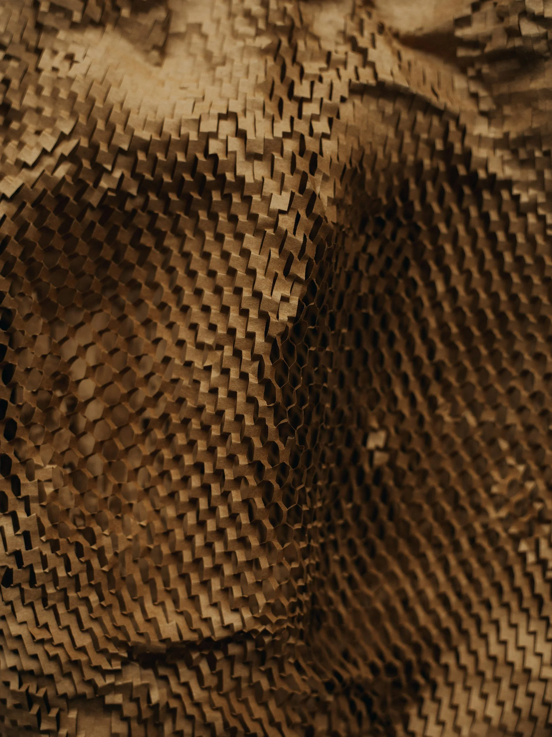 Close-up of crumpled brown paper with a textured, wavy pattern.