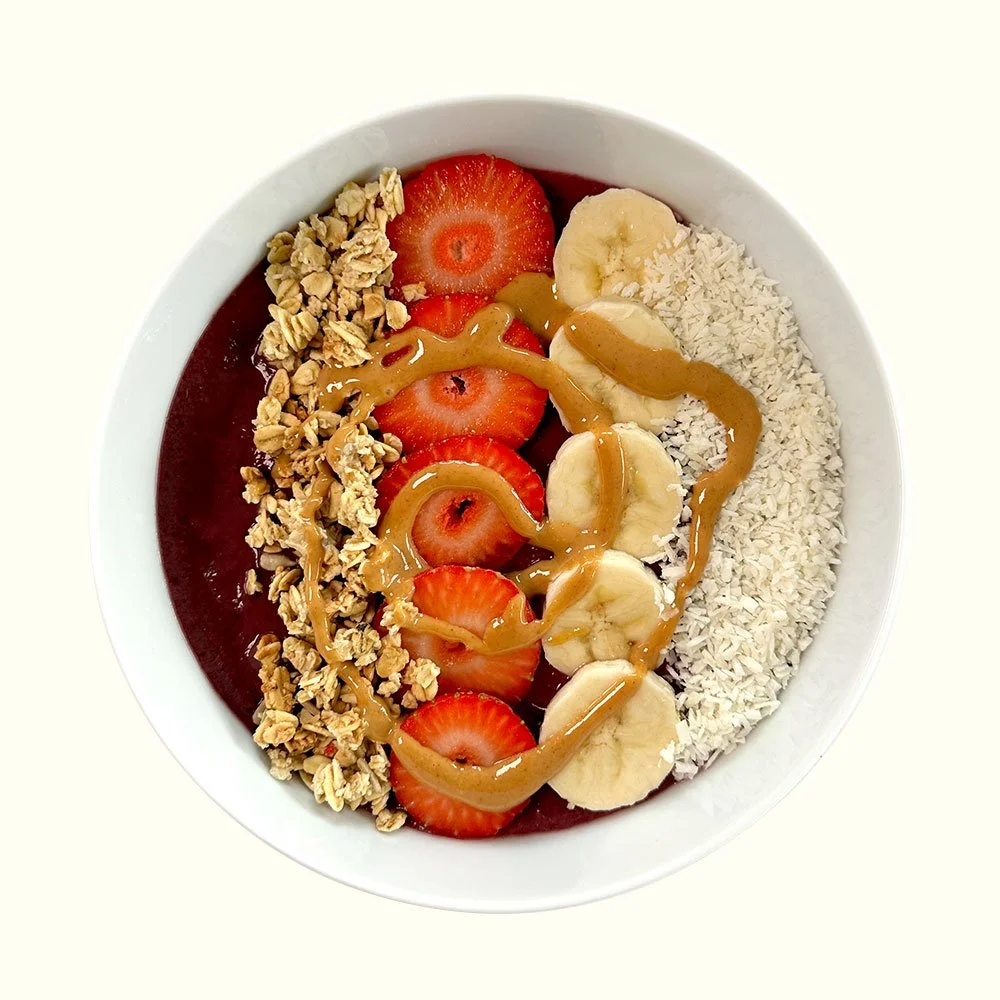 The Acai - Organic acai, vegan and organic granola, coconut, strawberry, banana, almond butter drizzle.