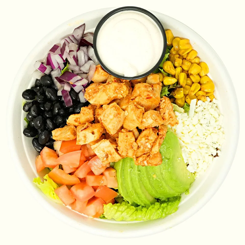 Santa Fe Chicken - Chipotle chicken, romaine, spring mix, roasted corn, black beans, red onion, tomato, cheese blend, avocado, served with Baja ranch.