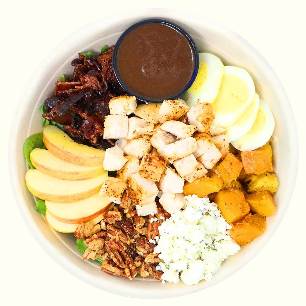 Fall chicken Cobb - Blackened chicken, arugula, spinach, egg, candied bacon, rosemary goat cheese,
candied pecan, roasted butternut squash, apple with a fig vinaigrette. 