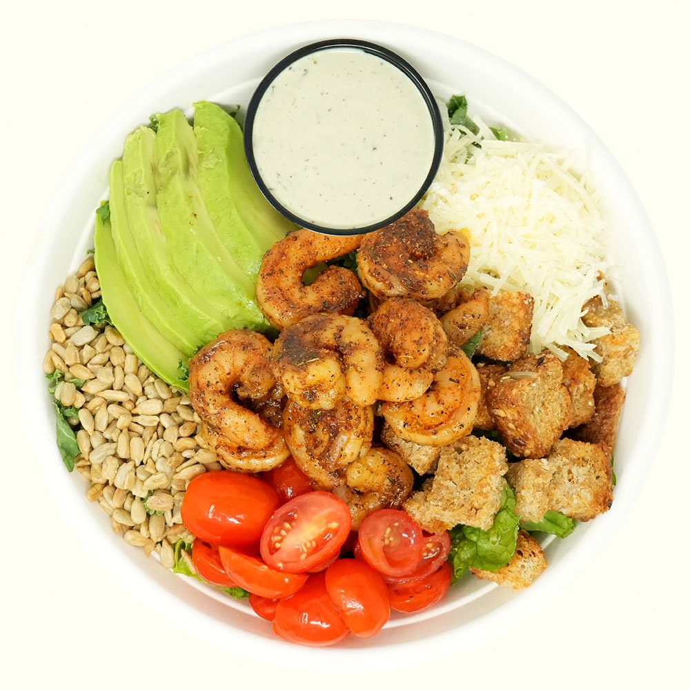 Shrimp Caesar - Blackened shrimp, romaine, sunflower seeds, tomato, parmesan cheese, gluten free croutons, avocado served with caesar dressing. 
Contains Gluten