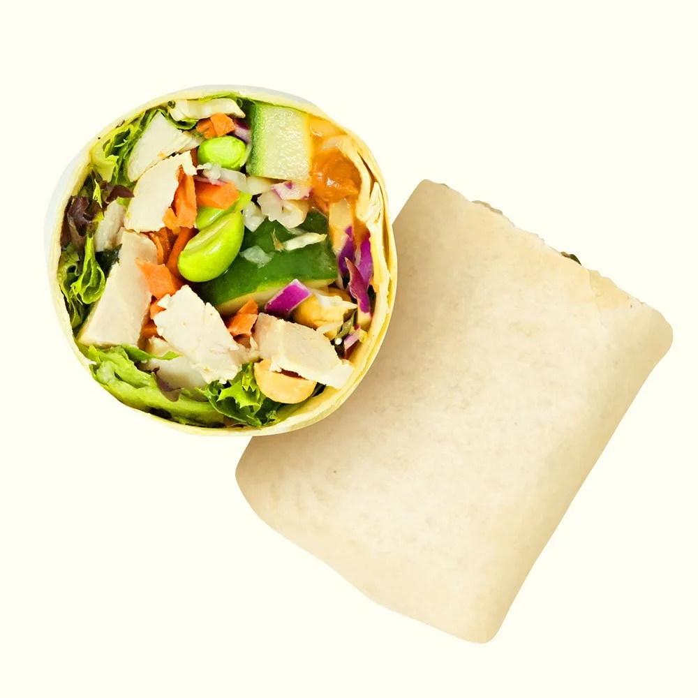Thai Peanut Chicken - All natural chicken, pickled carrots, cucumber, edamame, roasted peanuts, spring mix, cabbage, Asian ginger peanut drizzle in a flour wrap. Contains Gluten