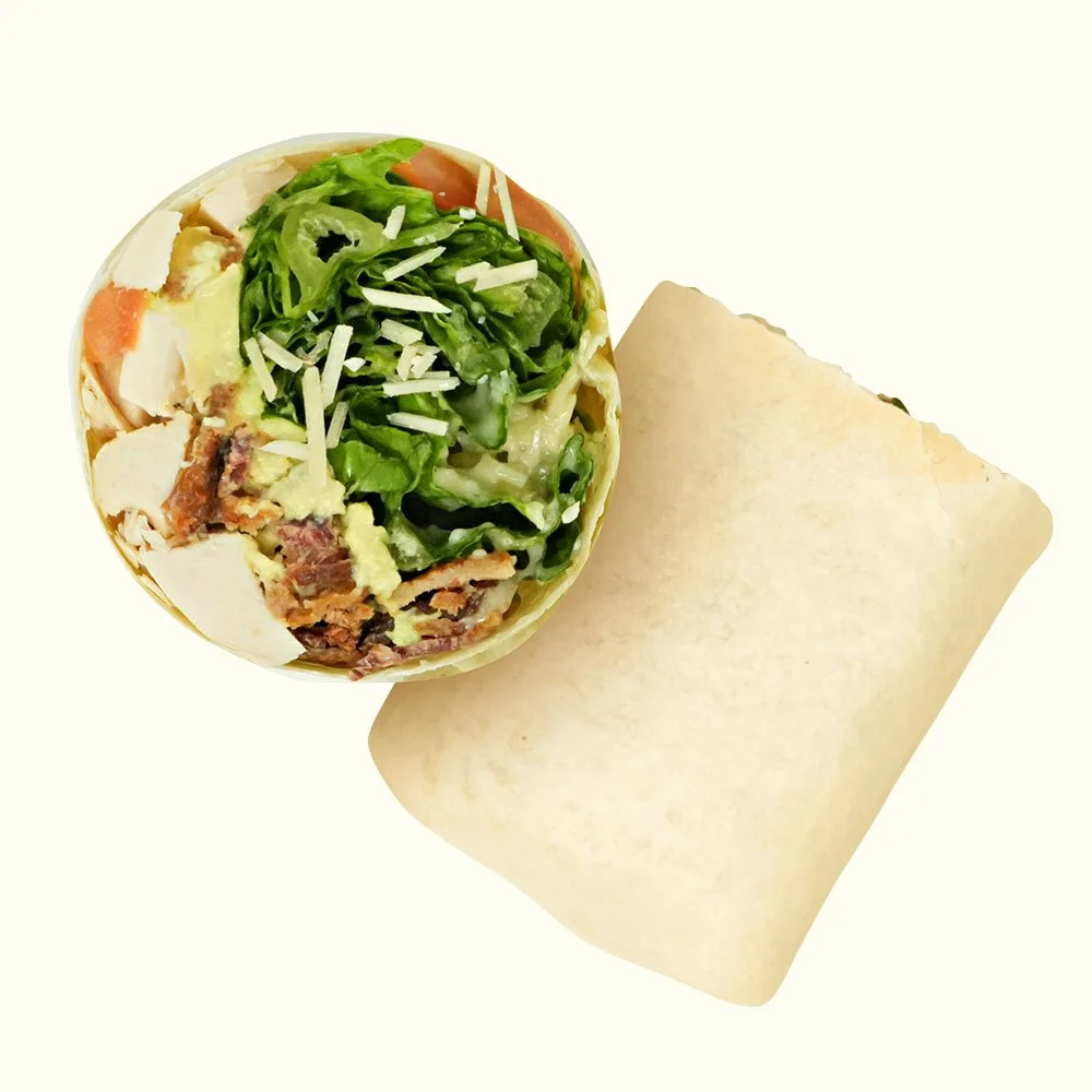 Chicken Caesar - All natural chicken, romaine, parmesan cheese, tomato, avocado, bacon, caesar dressing in a flour wrap. Contains Gluten