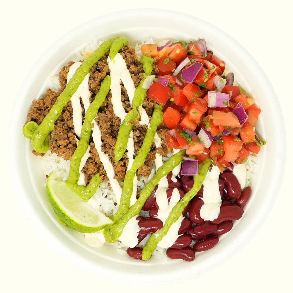 Beef Baja - Grass-fed ground beef, kidney bean, cheese blend, pico de gallo over jasmine rice with a spicy guacamole salsa and baja ranch drizzle with a lime wedge.