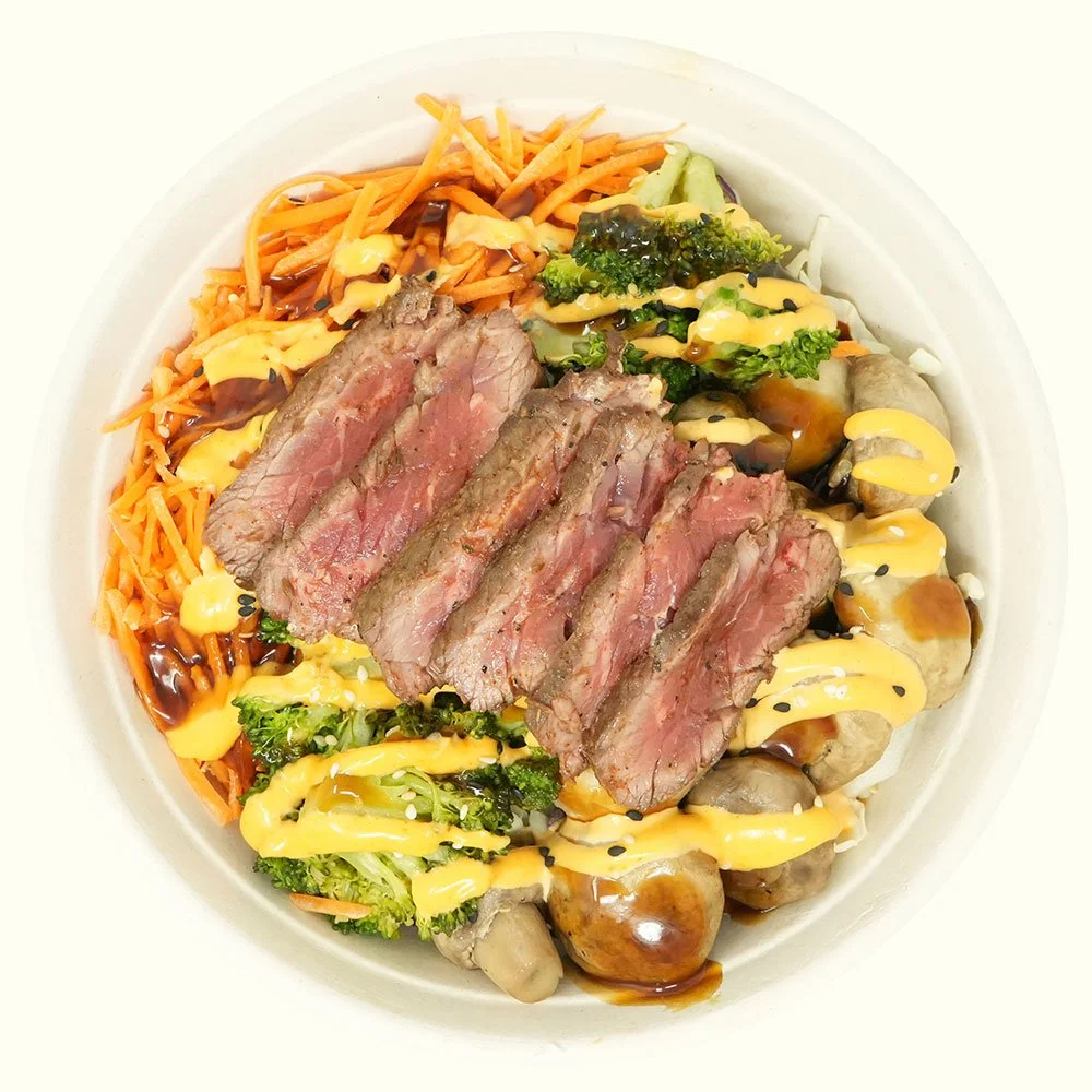 Steak Korean - Grass-fed steak, rice quinoa blend, roasted mushroom, broccoli, shaved carrot and cabbage, sesame seeds, with teriyaki and Korean chili aioli.