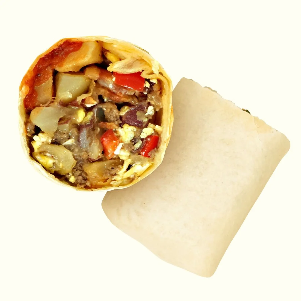 Breakfast Burrito - Grass-fed ground beef, scrambled eggs, bell pepper, onion, bacon, cheese blend, seasoned red potatoes, parsley, with a house made ketchup in a flour wrap. Contains Gluten