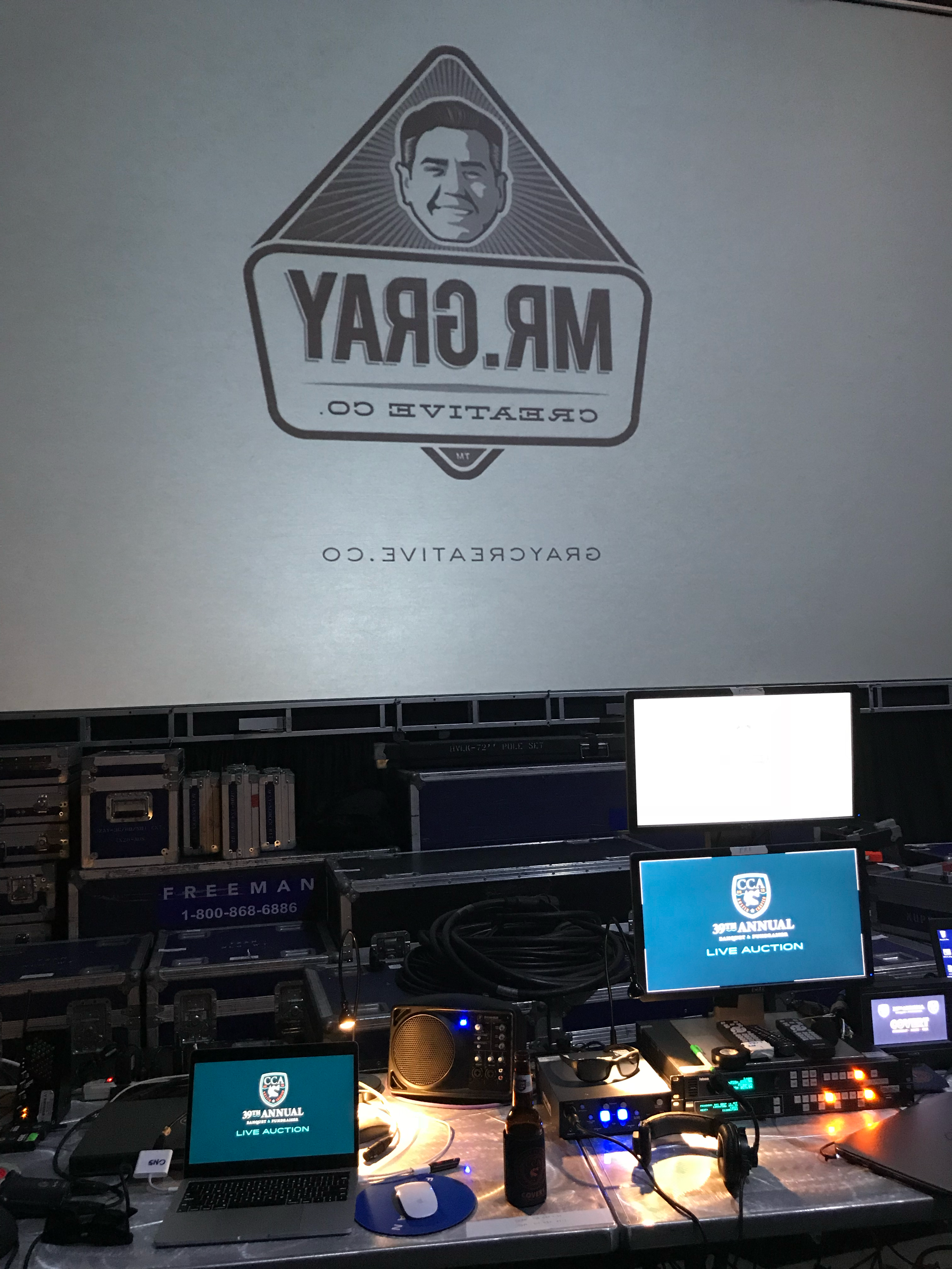 My setup behind the main stage, where I work with the AV company to coordinate the displays on the three main screens.