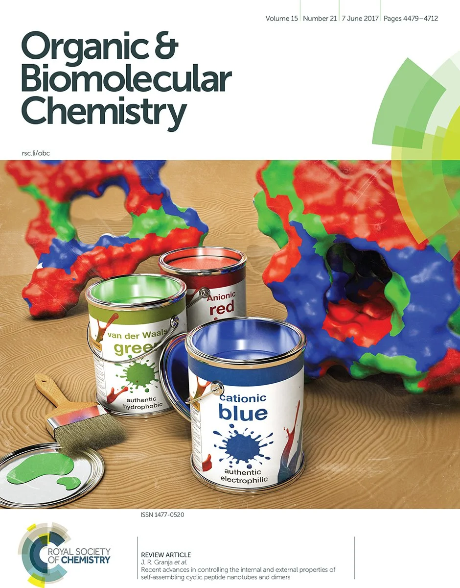 Cover of a scientific journal titled 'Organic & Biomolecular Chemistry' featuring colorful molecular models and paint cans labeled with different chemical properties and colors.