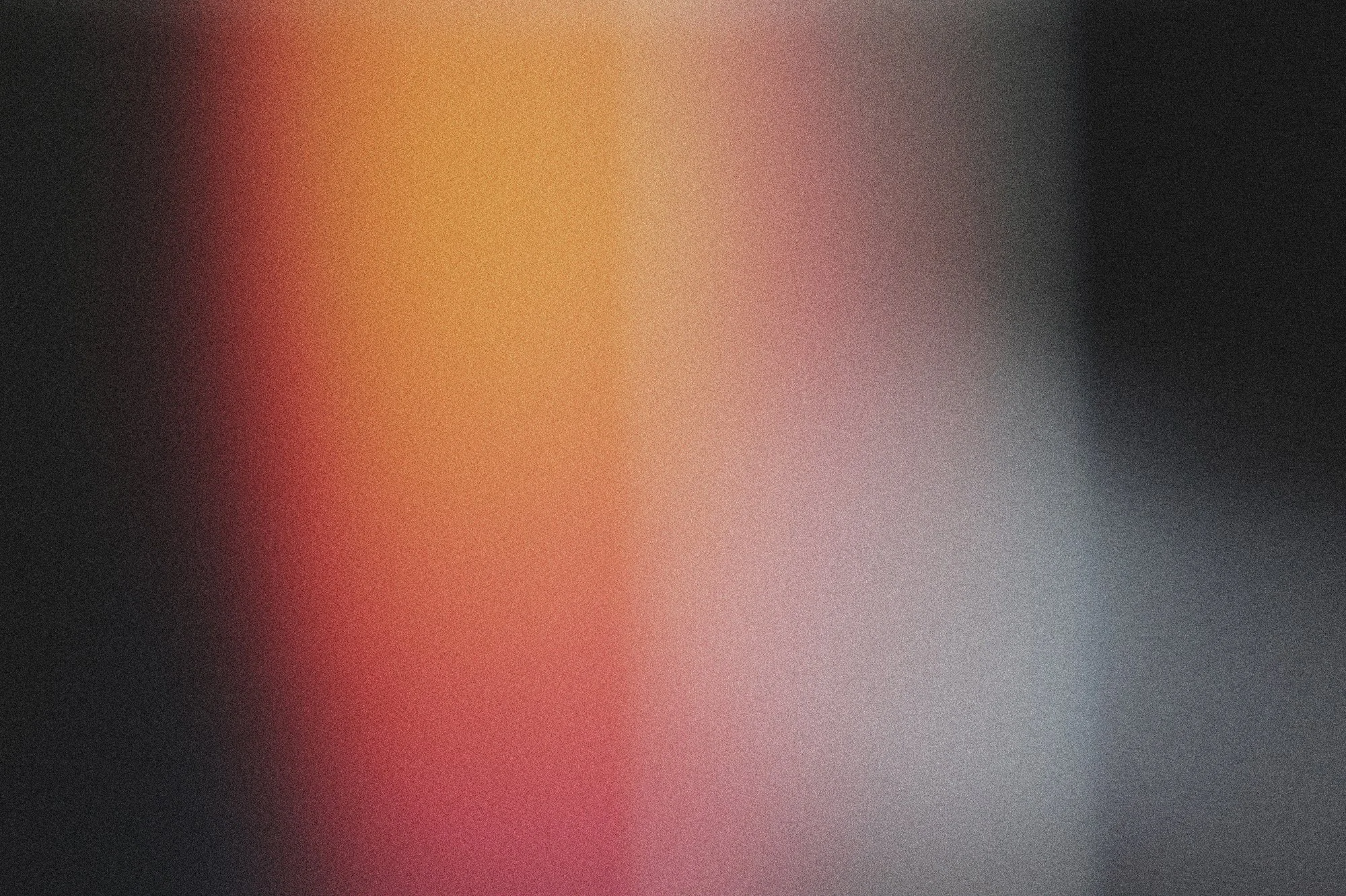 Blurred abstract background with gradient colors from orange to pink to dark gray.