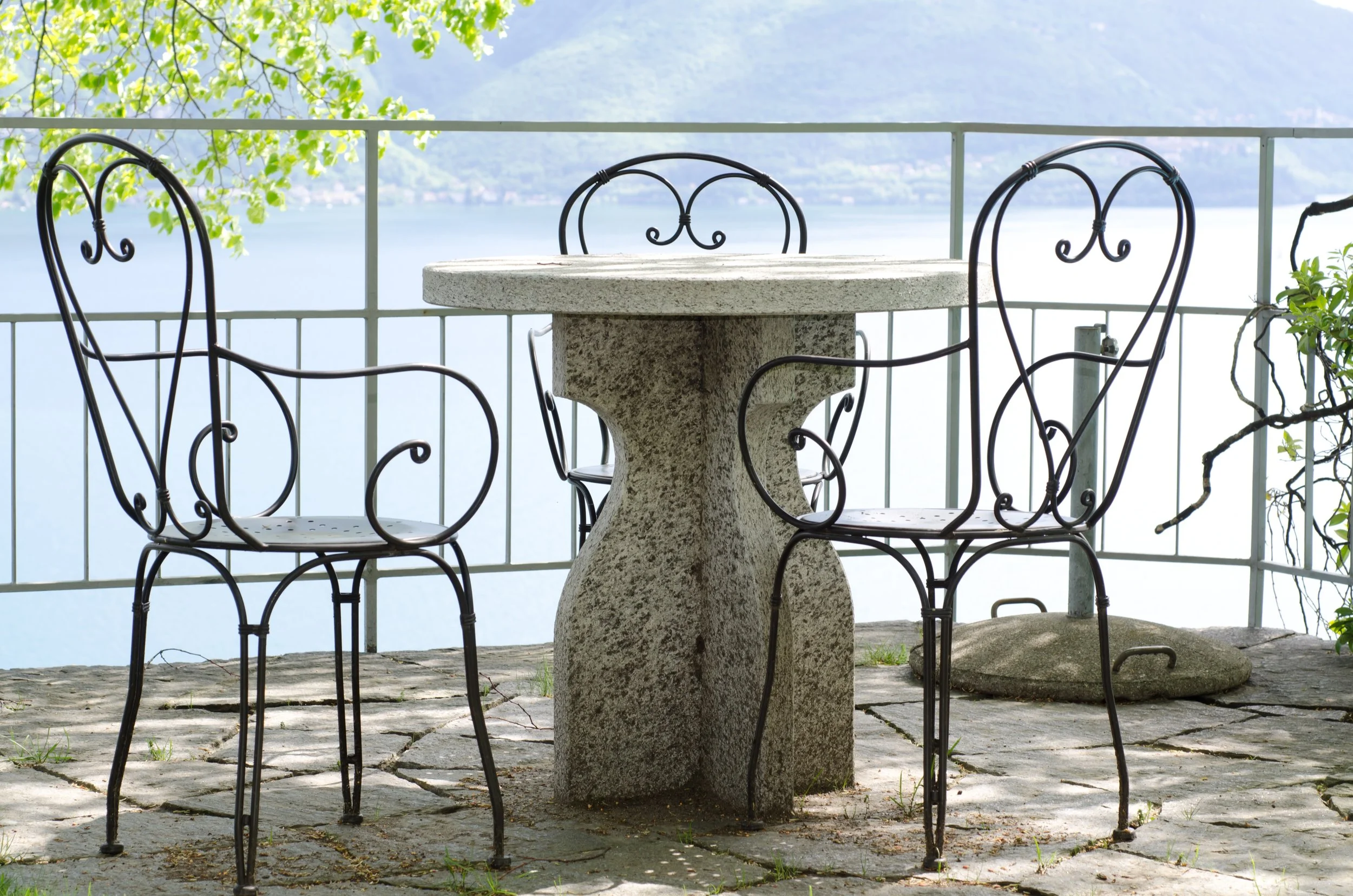 patio-with-stone-table-chairs-with-view-lake.jpg