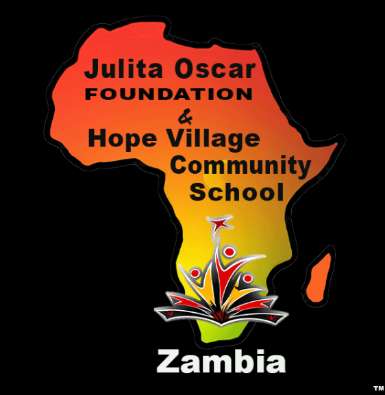 The image features an outline of Africa filled with a gradient of red, orange, yellow, and green colors. Text within the outline reads "Julita Oscar Foundation & Hope Village Community School". Below the outline, there is a stylized open book with abstract figures emerging from it, and the word "Zambia" appears at the bottom.