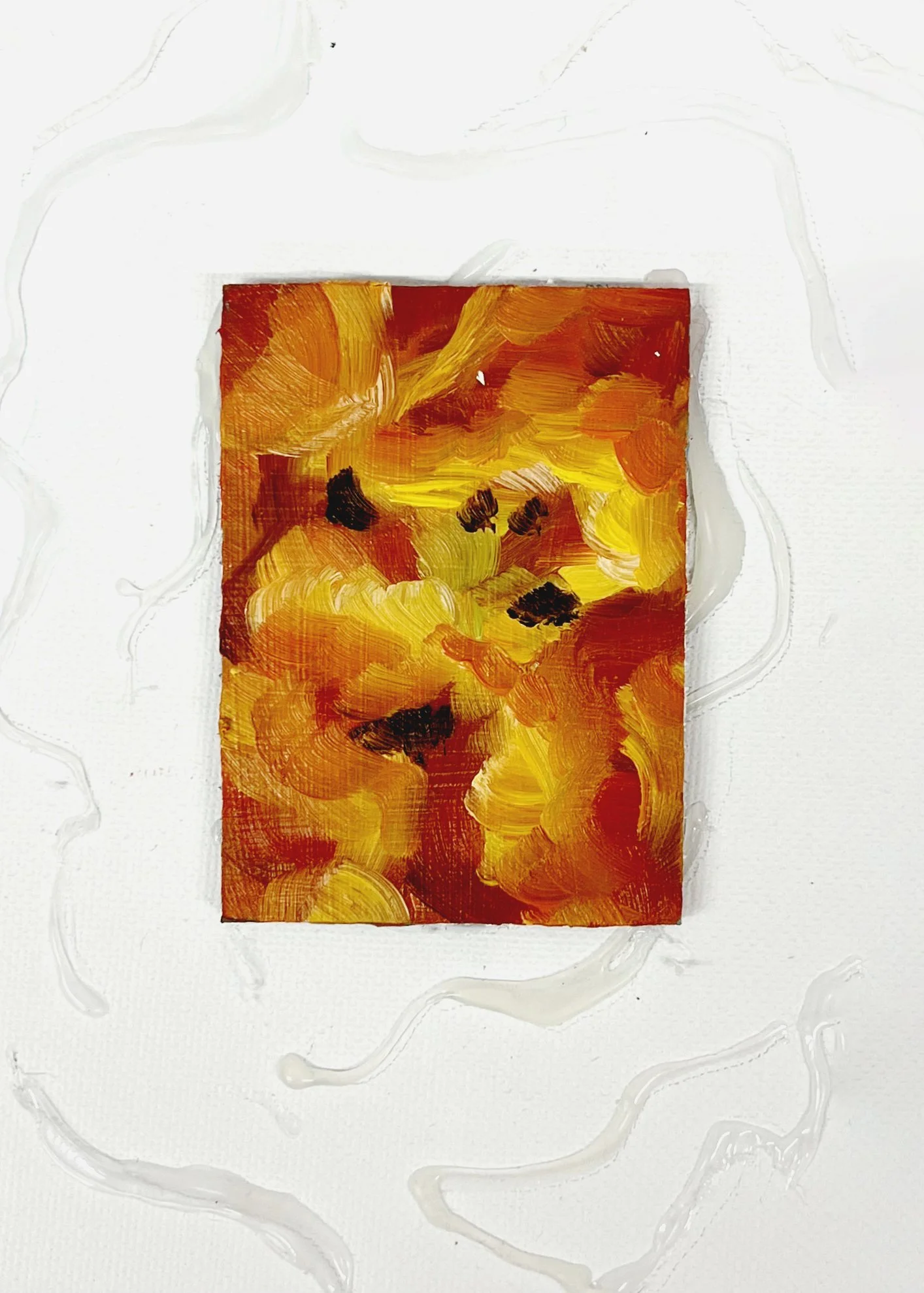 Abstract painting with swirling strokes of yellow, orange, and black on a small rectangular canvas, surrounded by a white background with textured white lines.