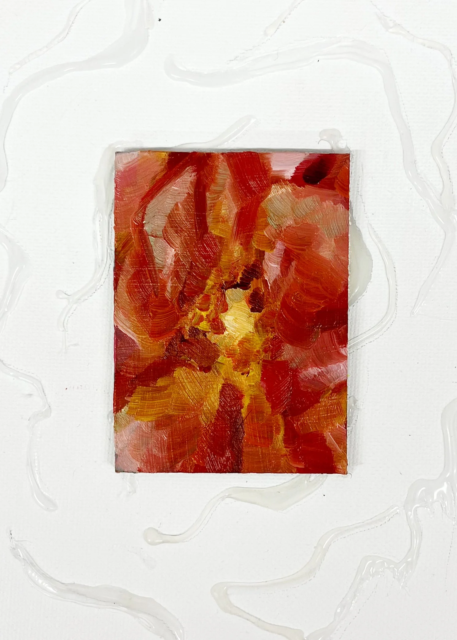 Abstract painting with warm colors, predominantly red, orange, and yellow, on a small canvas, with white background and textured paint streaks.