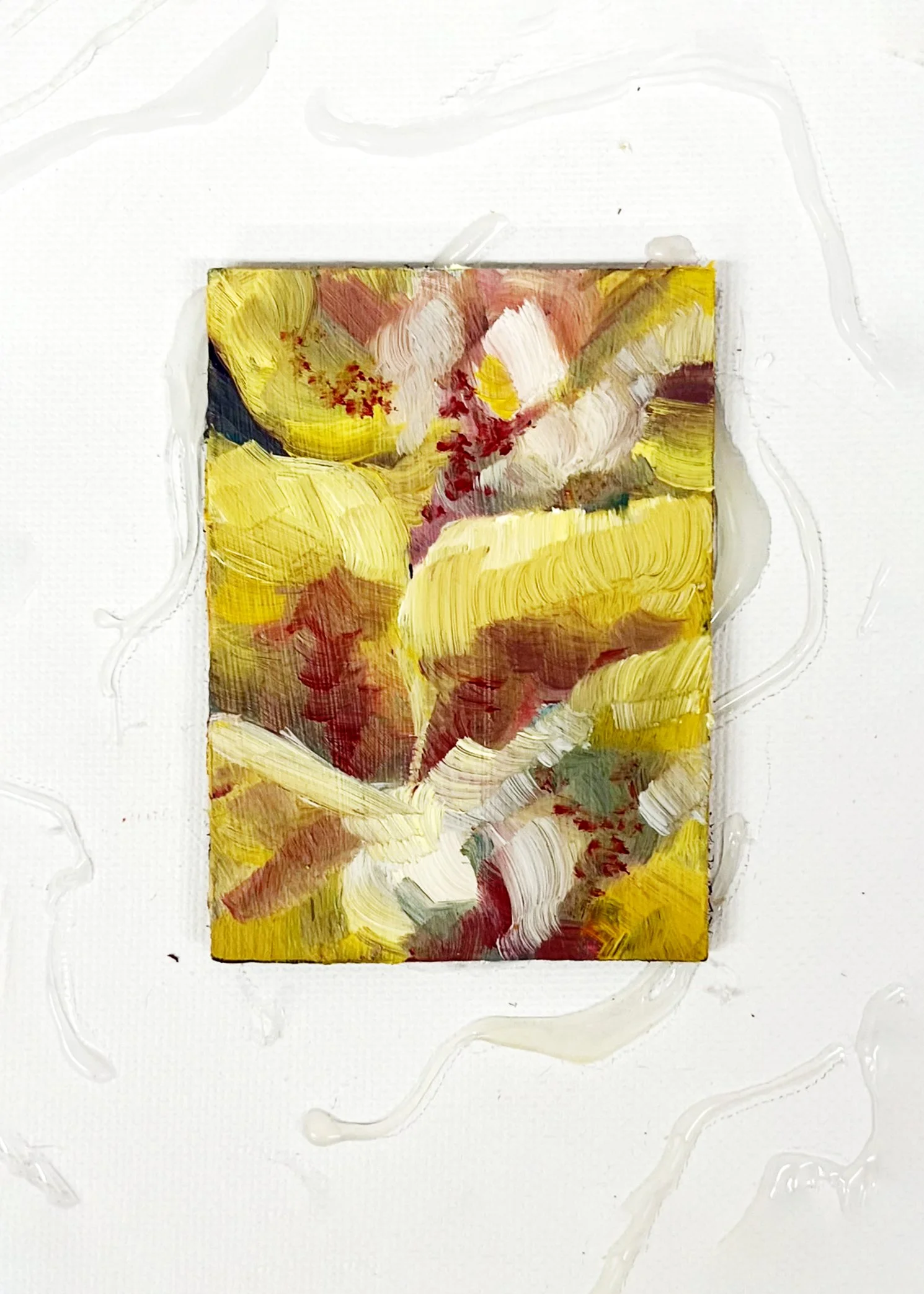Abstract painting with yellow, white, red, and green brushstrokes on a small canvas with white background.