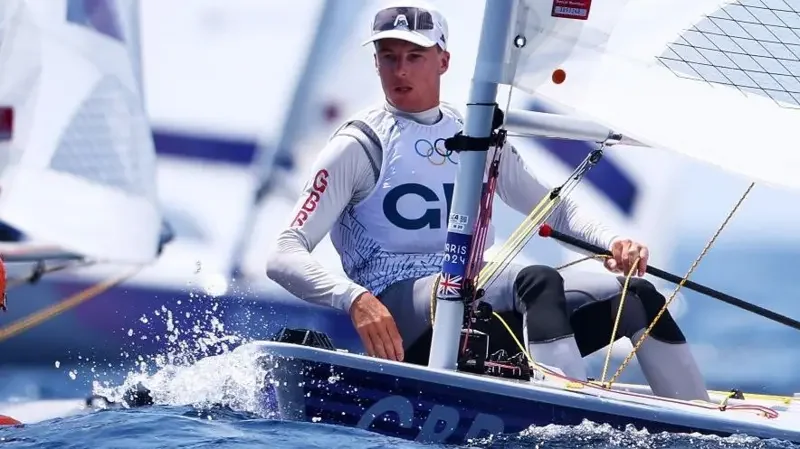 Team GB Olympic ILCA Sailor racing his boat wearing a Team GB Bib