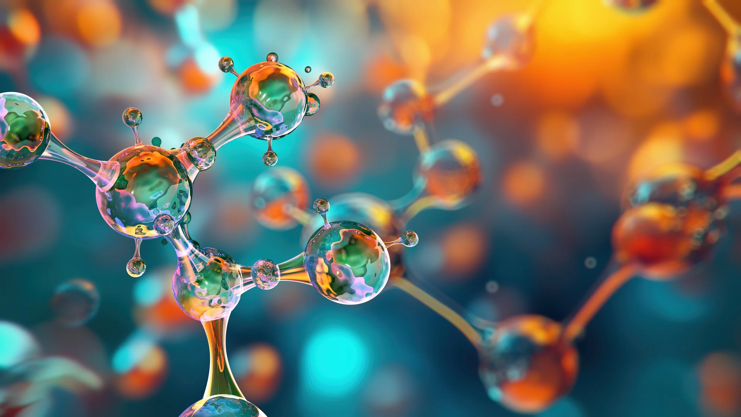 Close-up of colorful molecular or atomic structures with spheres connected by rods, set against a vibrant, blurred background.