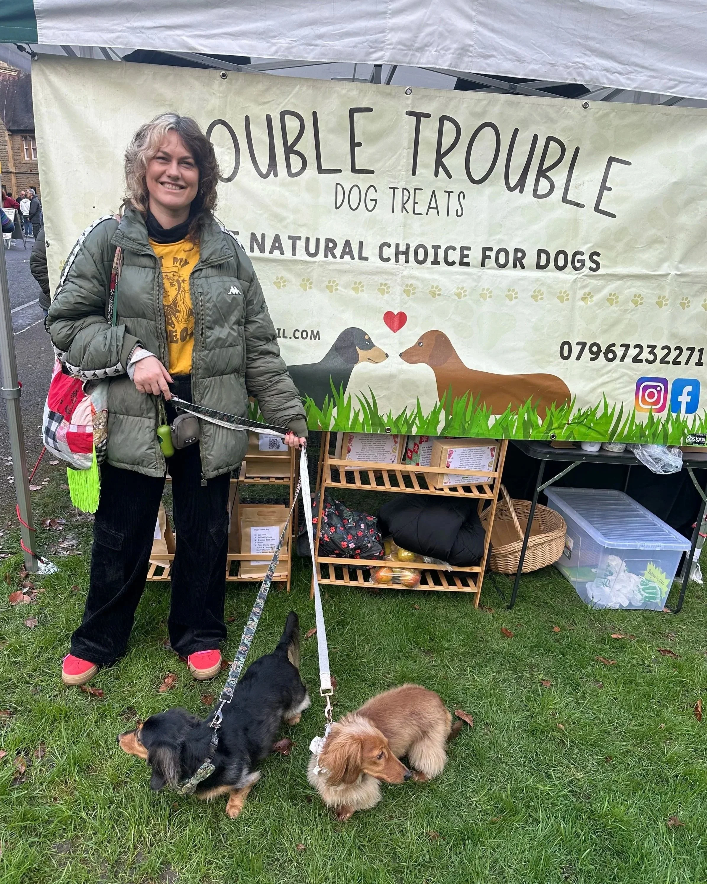 Louise Kehoe at an independent market with her dachshunds Dolly and Frankie, enjoying local businesses and community events.