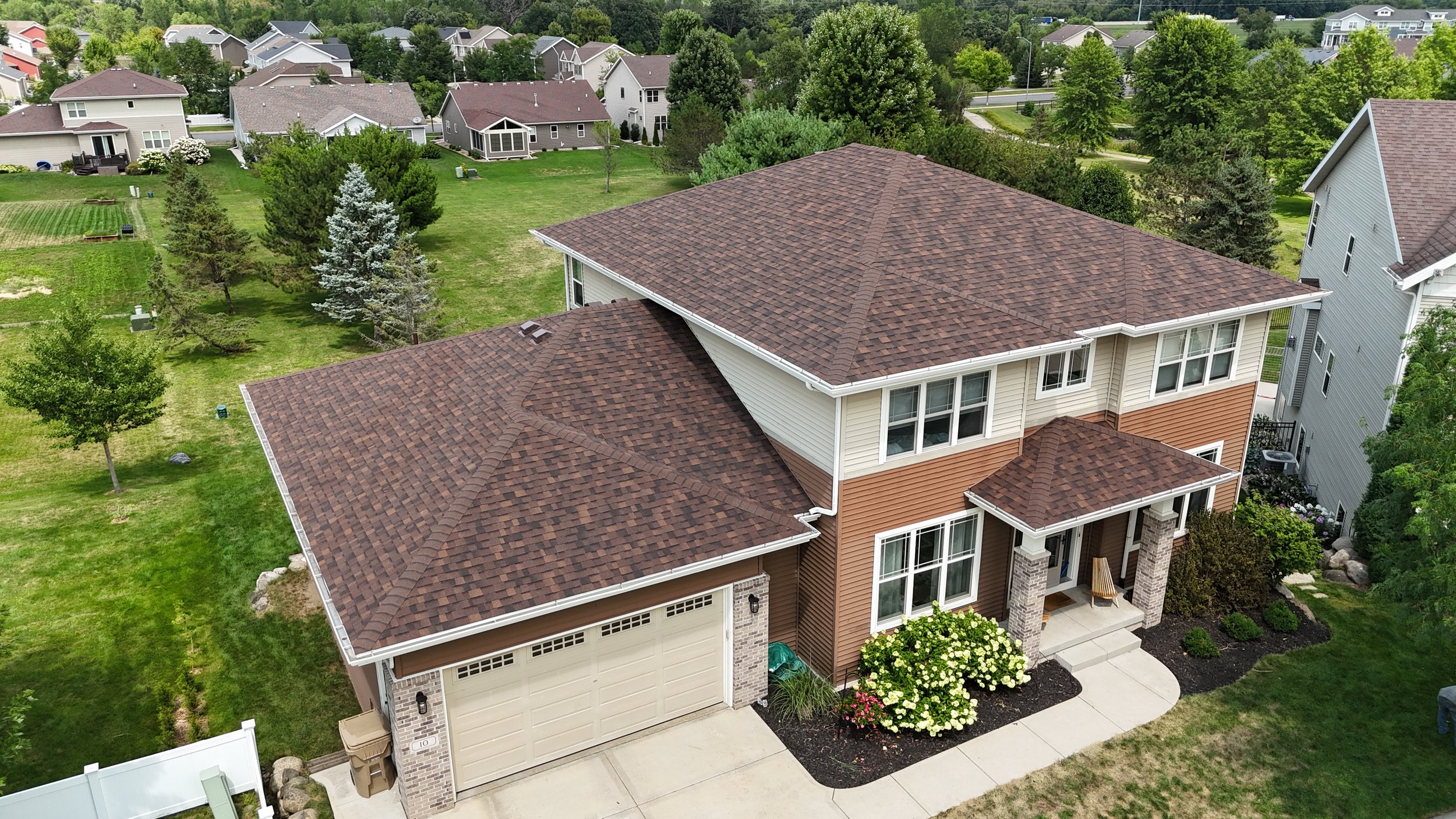 Aerial view of a two-story home with an Owens Corning Duration Brownwood shingle roof.
