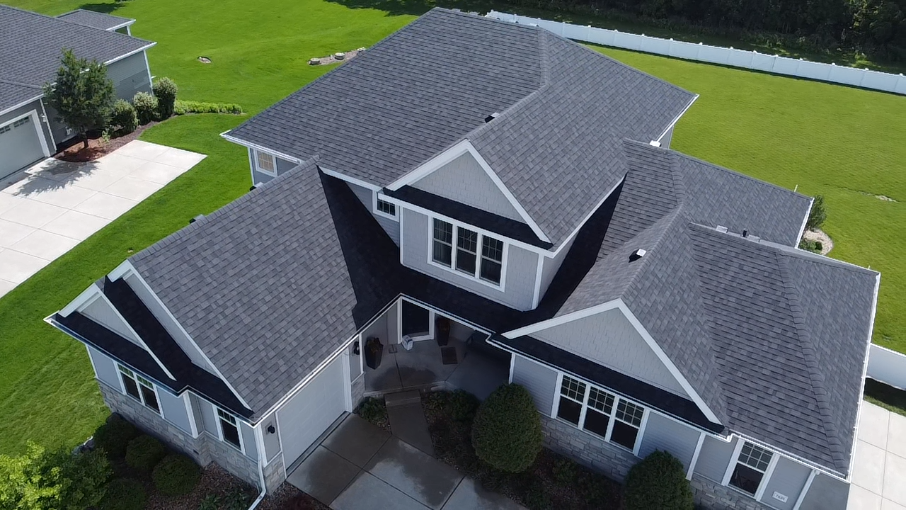 Front aerial view of a residential home with Owens Corning Duration Flex Onyx Black shingles.