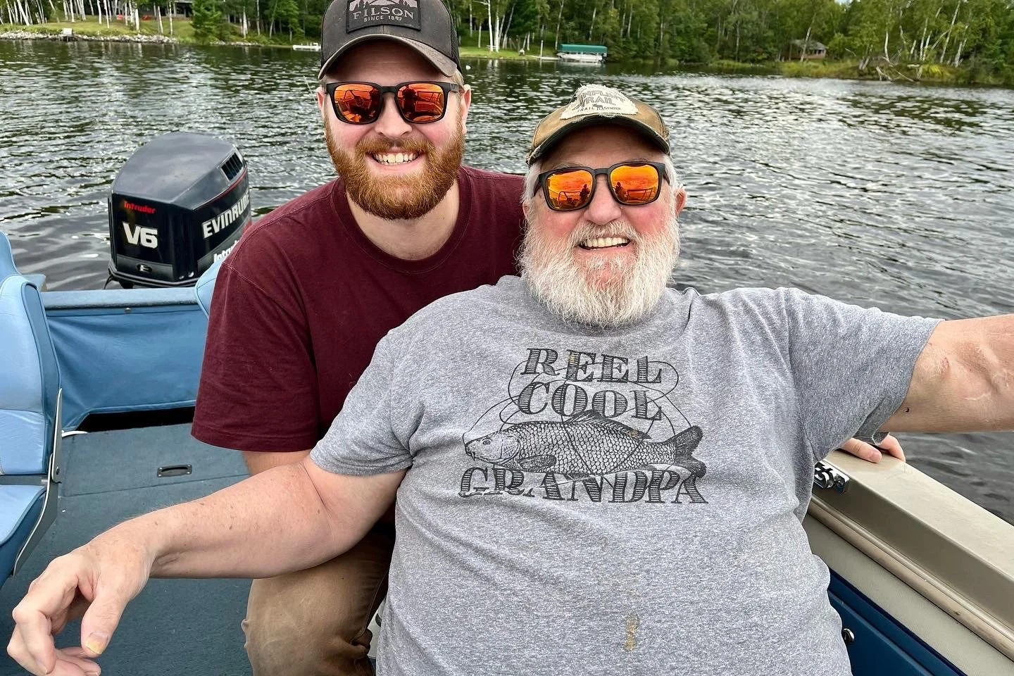 Family photo of two men together on a boat, featured in the story behind the John Hirt Construction name.