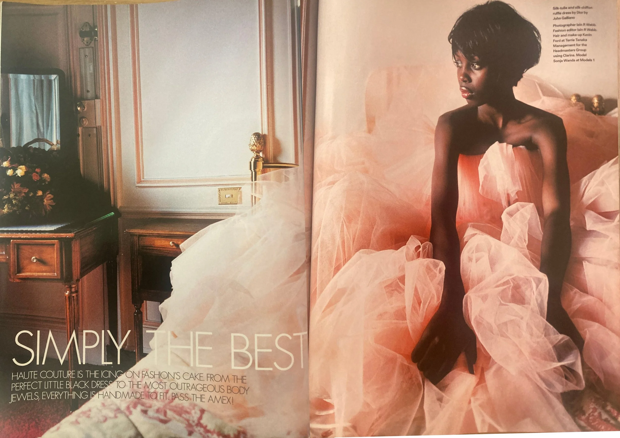 Double page fashion editorial from ELLE UK December 2003 showing a black woman with short hair wearing a pink couture dress.