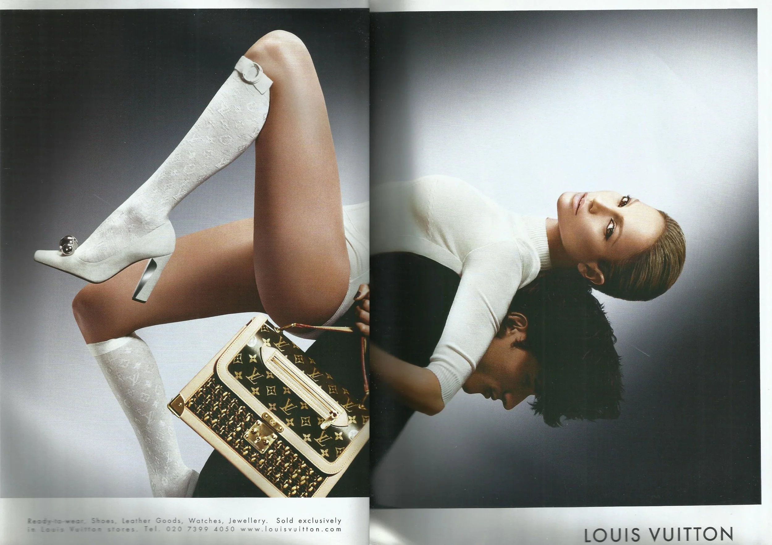 Advert for Louis Vuitton featuring singer Jennifer Lopez wearing a white body suit with white heels and white stockings. Posing on the back of a male model holding a Louis Vuitton bag