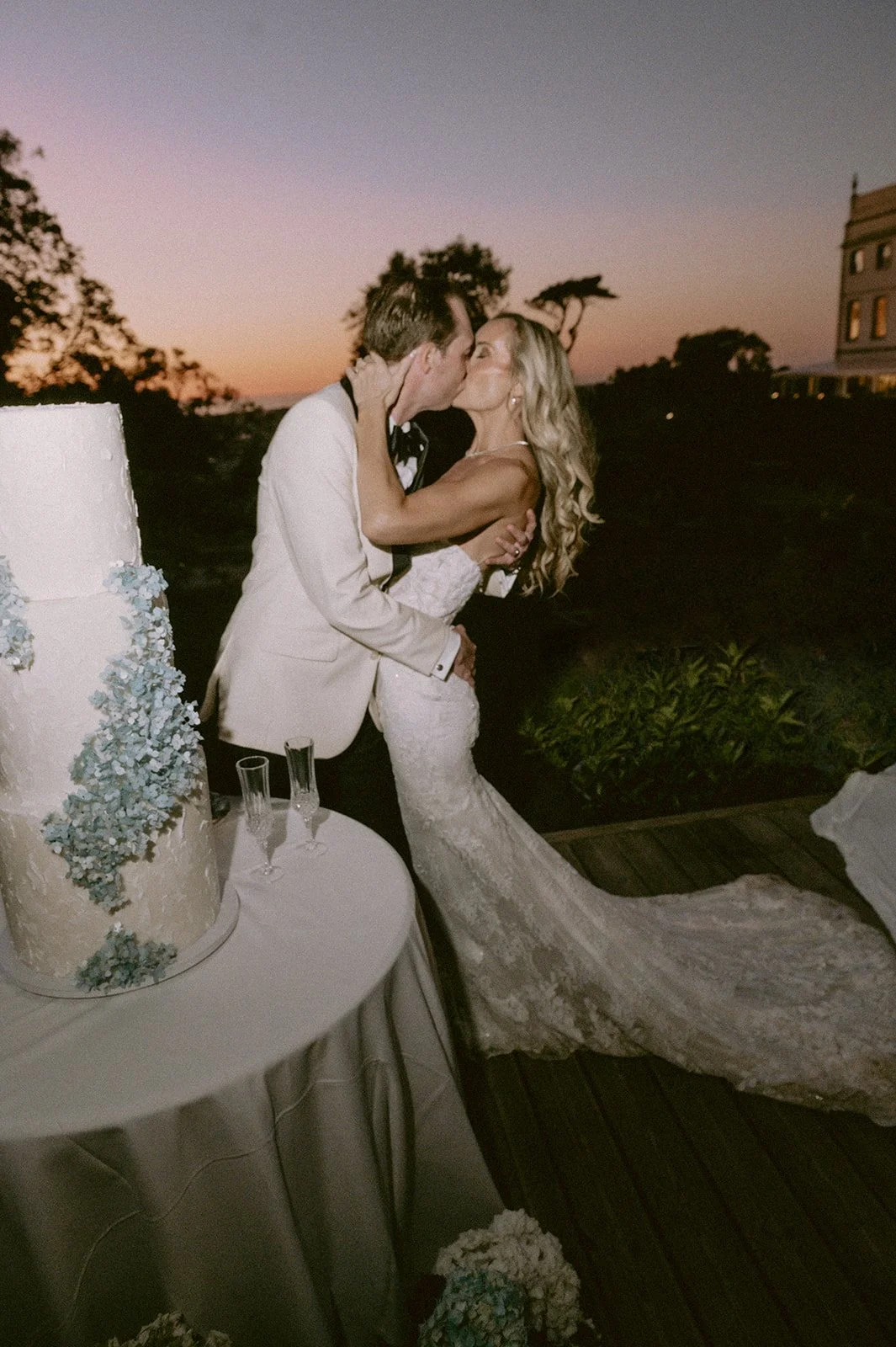 Jeni and Trevor by the cake at sunset