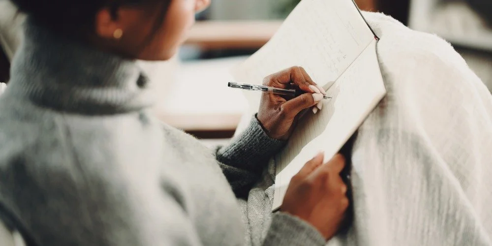 A person journaling after their therapy session to support their journey through growth and change