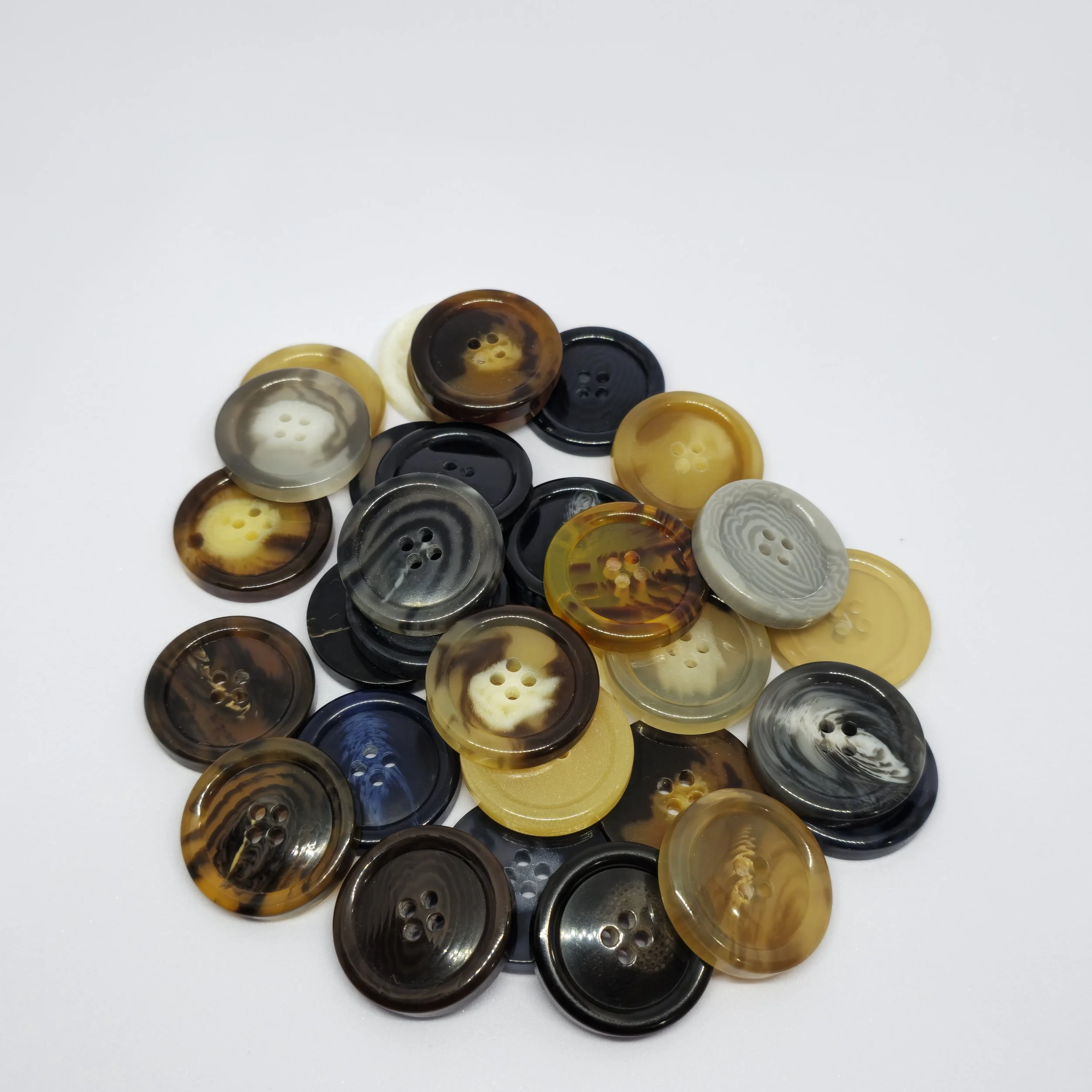 Coat, tuxedos and Suit buttons, made of polyester resin and bio-based resin.