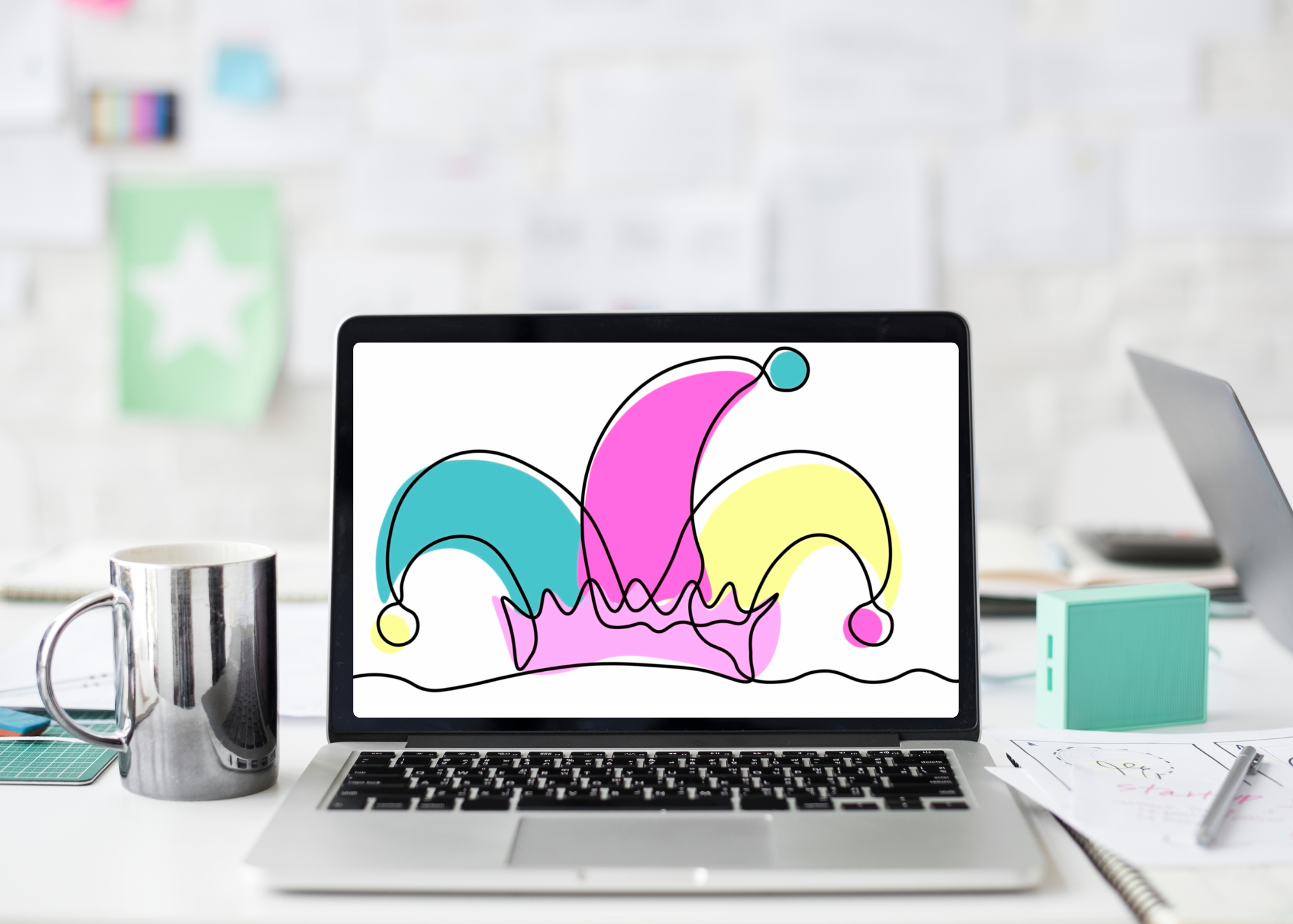 A laptop on a white desk displaying an abstract colorful doodle with pink, blue, and yellow shapes and black lines.