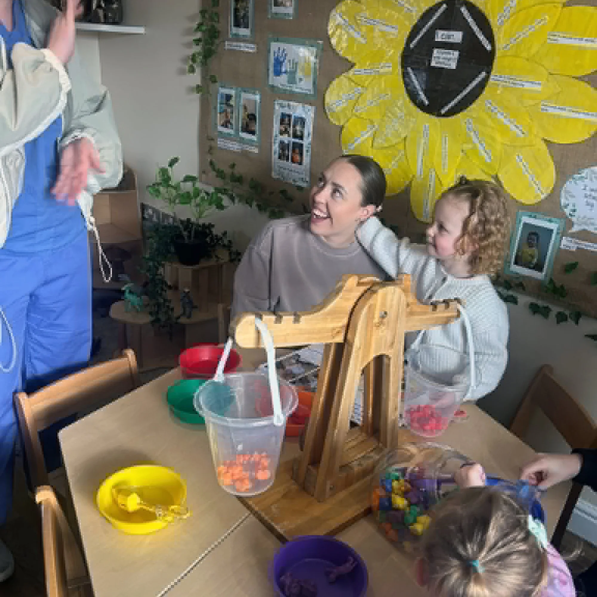 Children taking part in a sensory weighing play activity at The Ducklings Day Nursery.