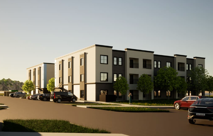 Modern multi-story apartment buildings with black and white exterior, surrounded by green trees and parked cars.