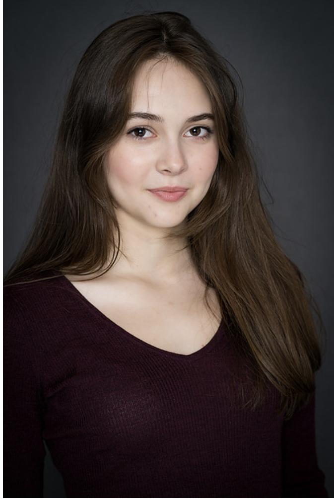 Image of Abigail Coleman. Headshot of NYC Based actress. Deep purple shirt and messy hair.