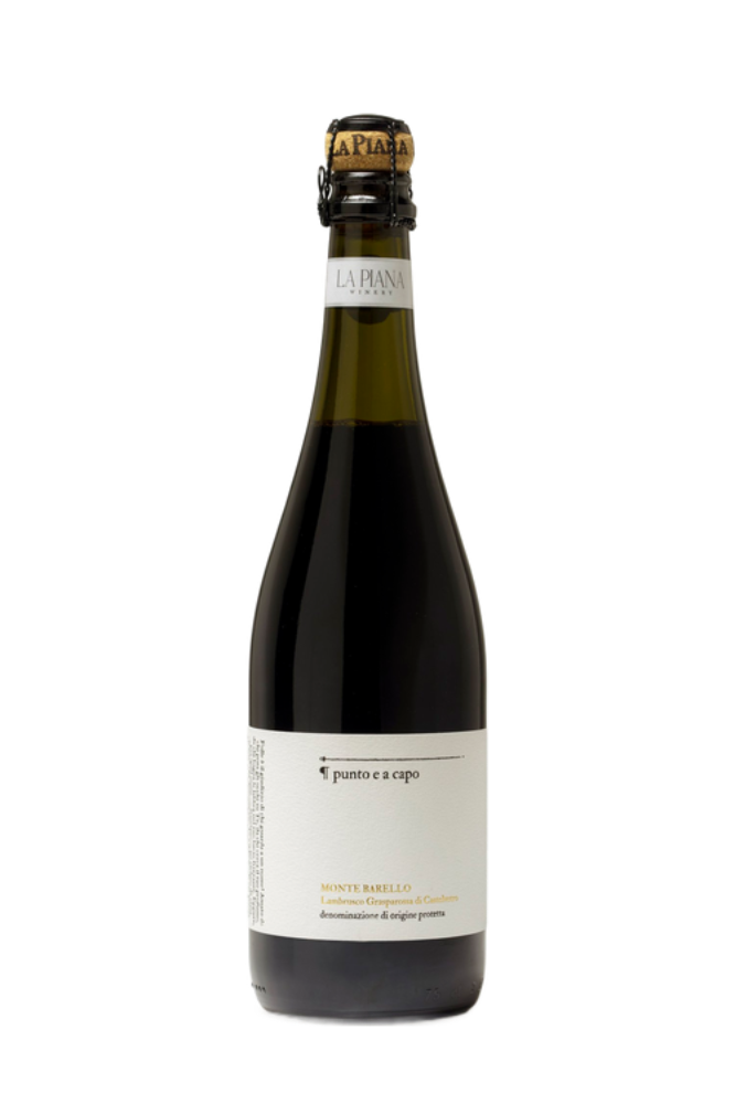 A dark glass bottle of Montebarello Lambrusco wine with a white label and a swing-top cap.