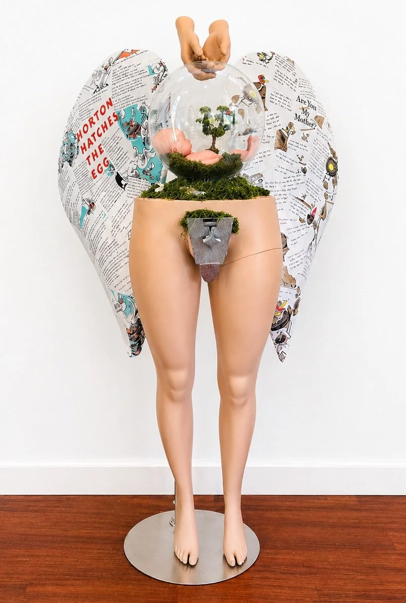The Surrogate, 2026. This is a complicated piece, as everyone's situation is different. Her womb, a terrarium, is Mother Earth, the source of all life. The baby's placenta is a tree, as the surrogate is growing a family tree. The two birds in the tre