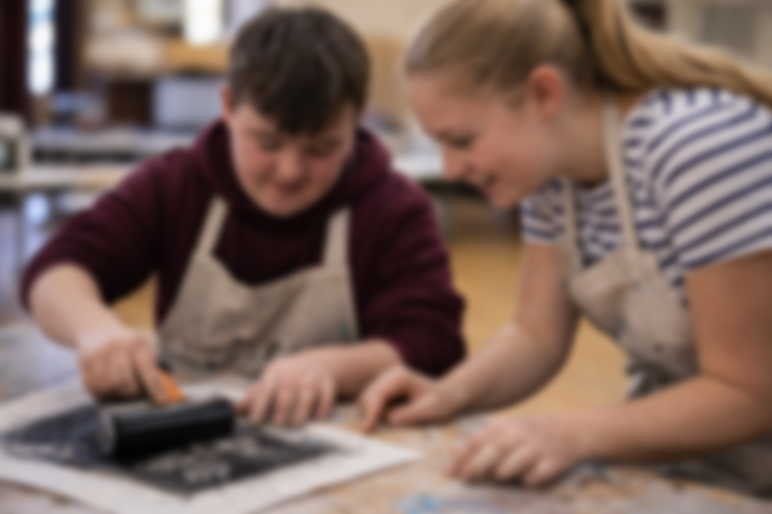 Two young people working together on printmaking during a structured session