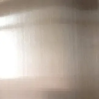 Blurred, metallic surface with vertical streaks and reflections.