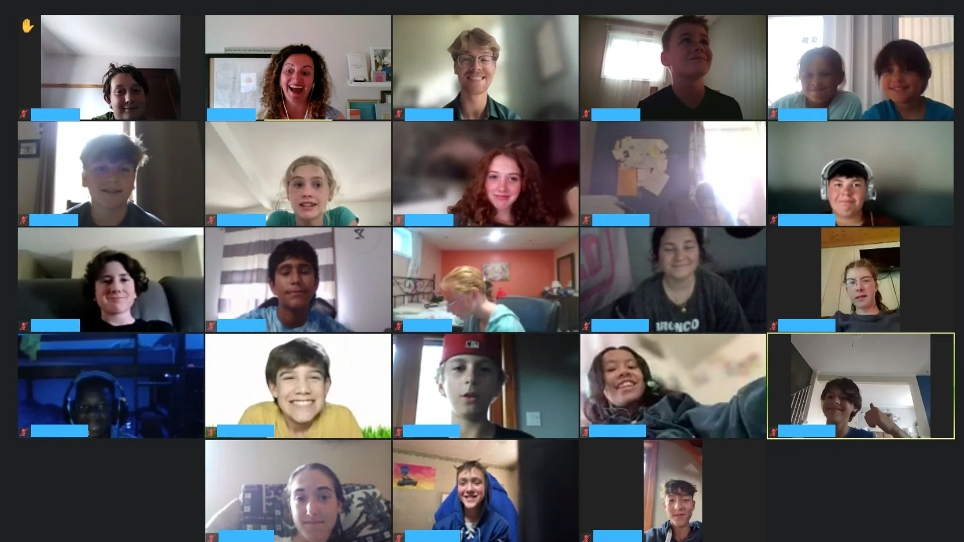 Zoom video call screen with multiple young children and a few adults, all smiling or making playful gestures.